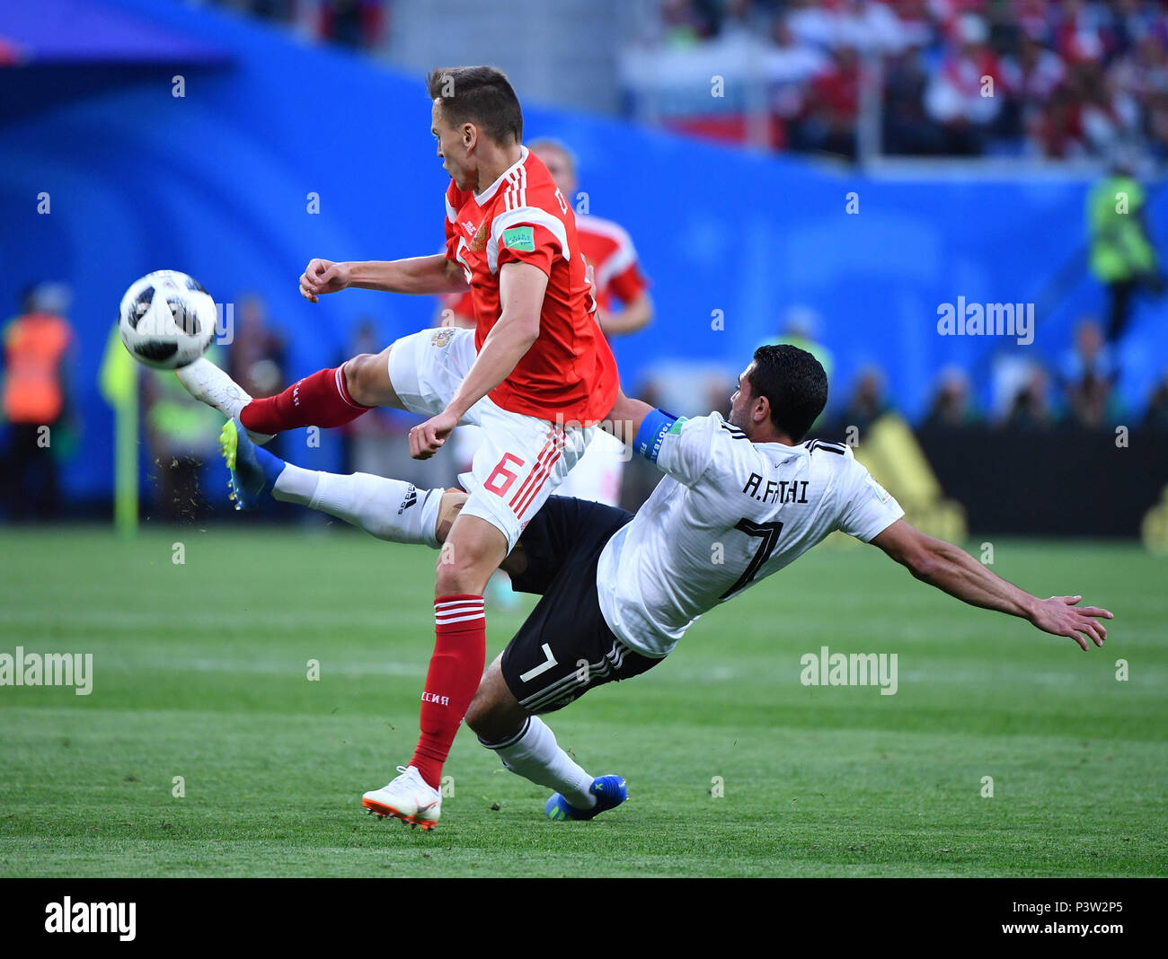 Saint Petersburg, Russia. 19th June, 2018. Denis Cheryshev (L) of Russia vies with Ahmed Fathi of Egypt during a Group A match between Russia and Egypt at the 2018 FIFA World Cup in Saint Petersburg, Russia, June 19, 2018. Credit: Li Ga/Xinhua/Alamy Live News Stock Photo