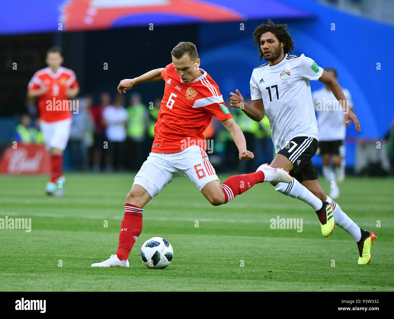 Saint Petersburg, Russia. 19th June, 2018. Denis Cheryshev (L) of Russia passes the ball during a Group A match between Russia and Egypt at the 2018 FIFA World Cup in Saint Petersburg, Russia, June 19, 2018. Credit: Li Ga/Xinhua/Alamy Live News Stock Photo