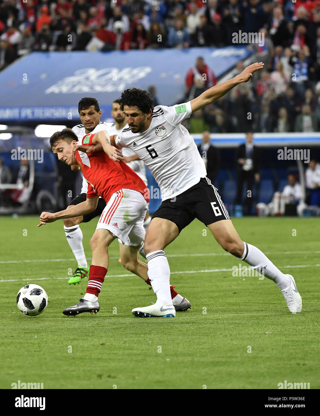 Saint Petersburg, Russia. 19th June, 2018. Aleksandr Golovin (L) of Russia vies with Ahmed Hegazy of Egypt during a Group A match between Russia and Egypt at the 2018 FIFA World Cup in Saint Petersburg, Russia, June 19, 2018. Russia won 3-1. Credit: Chen Yichen/Xinhua/Alamy Live News Stock Photo
