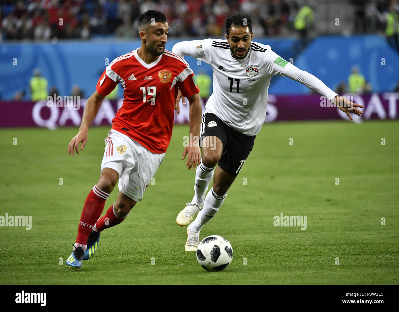 Saint Petersburg, Russia. 19th June, 2018. Alexandr Samedov (L) of Russia vies with Kahraba of Egypt during a Group A match between Russia and Egypt at the 2018 FIFA World Cup in Saint Petersburg, Russia, June 19, 2018. Russia won 3-1. Credit: Chen Yichen/Xinhua/Alamy Live News Stock Photo