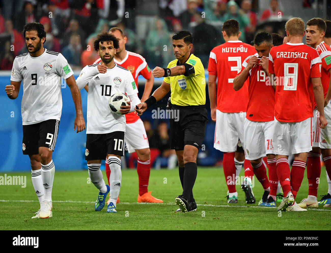 Saint Petersburg, Russia. 19th June, 2018. The referee awards Egypt a  penalty after Video Assistant Referee (VAR) review during a Group A match  between Russia and Egypt at the 2018 FIFA World