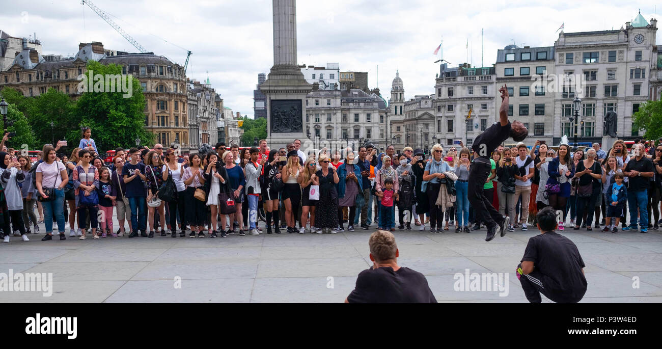 London, UK. 19th June 2018. Tourists gather in Trafalgar Square to watch street performers on a sunny afternoon. This was a display of breakdancing to hip hop music. ©Tim Ring/Alamy Live News Stock Photo