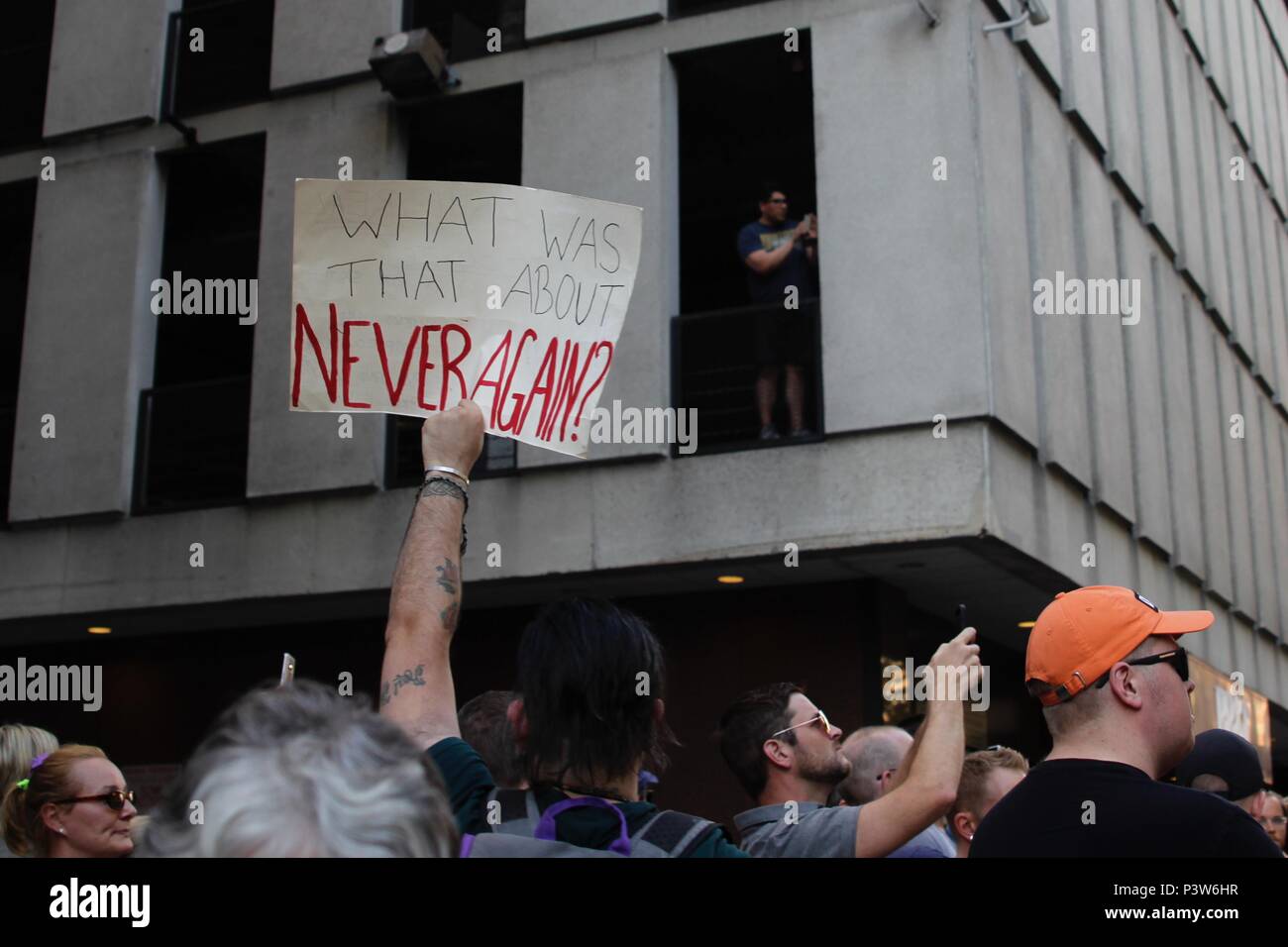 Philadelphia, PA, USA - June 19, 2018: A protester holds up a Never Again sign as thousands protest the Trump Administration policy of separating immigrant children and their parents at the U.S - Mexico border. Credit: Jana Shea/Alamy Live News Stock Photo