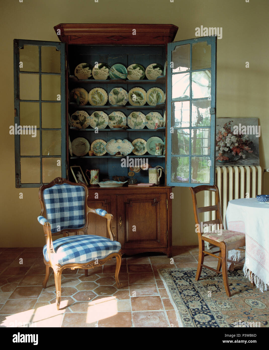 Blue White Checked Chair In Front Of Antique Dresser With Glass