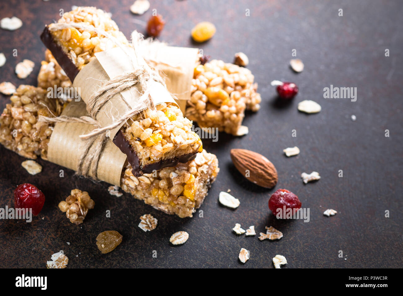 Granola bars. Fruit and grain granola bars on dark stone table Stock