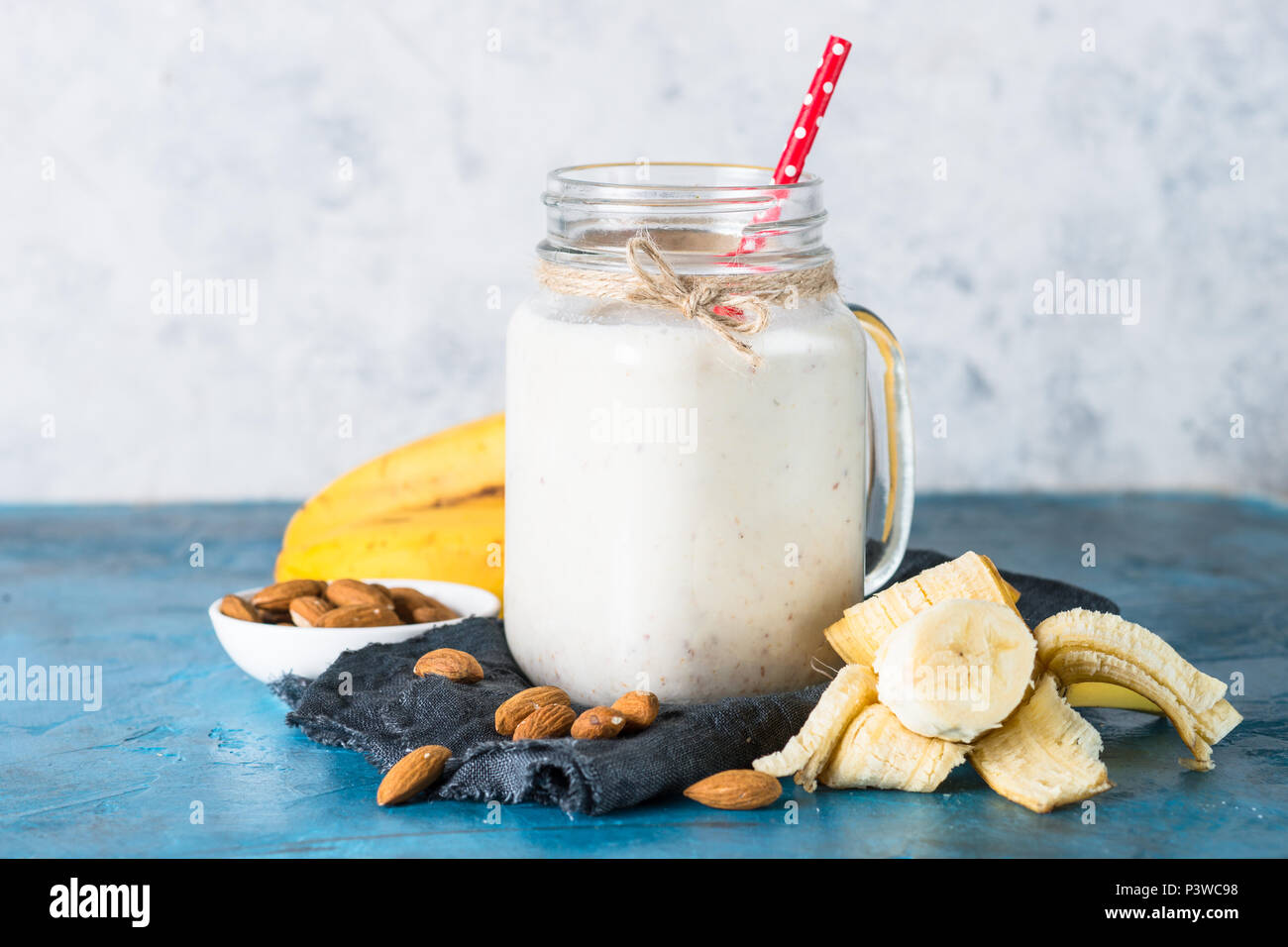 Shake or smoothie from almond milk, banana and coconut in a mason mug. Stock Photo