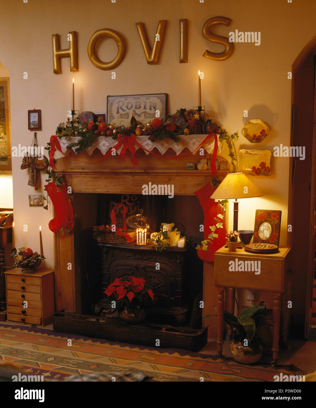 Gold Hovis" letters above fireplace with cast iron stove in dining room