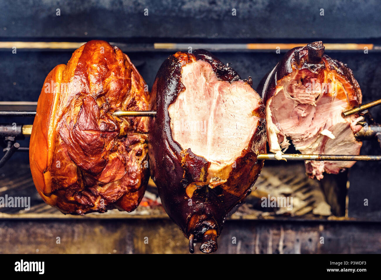 Traditional roasted shank ham cooking on charcoal spit roaster. Fresh and  juicy cutted meat. Prague, Czech Republic Stock Photo - Alamy