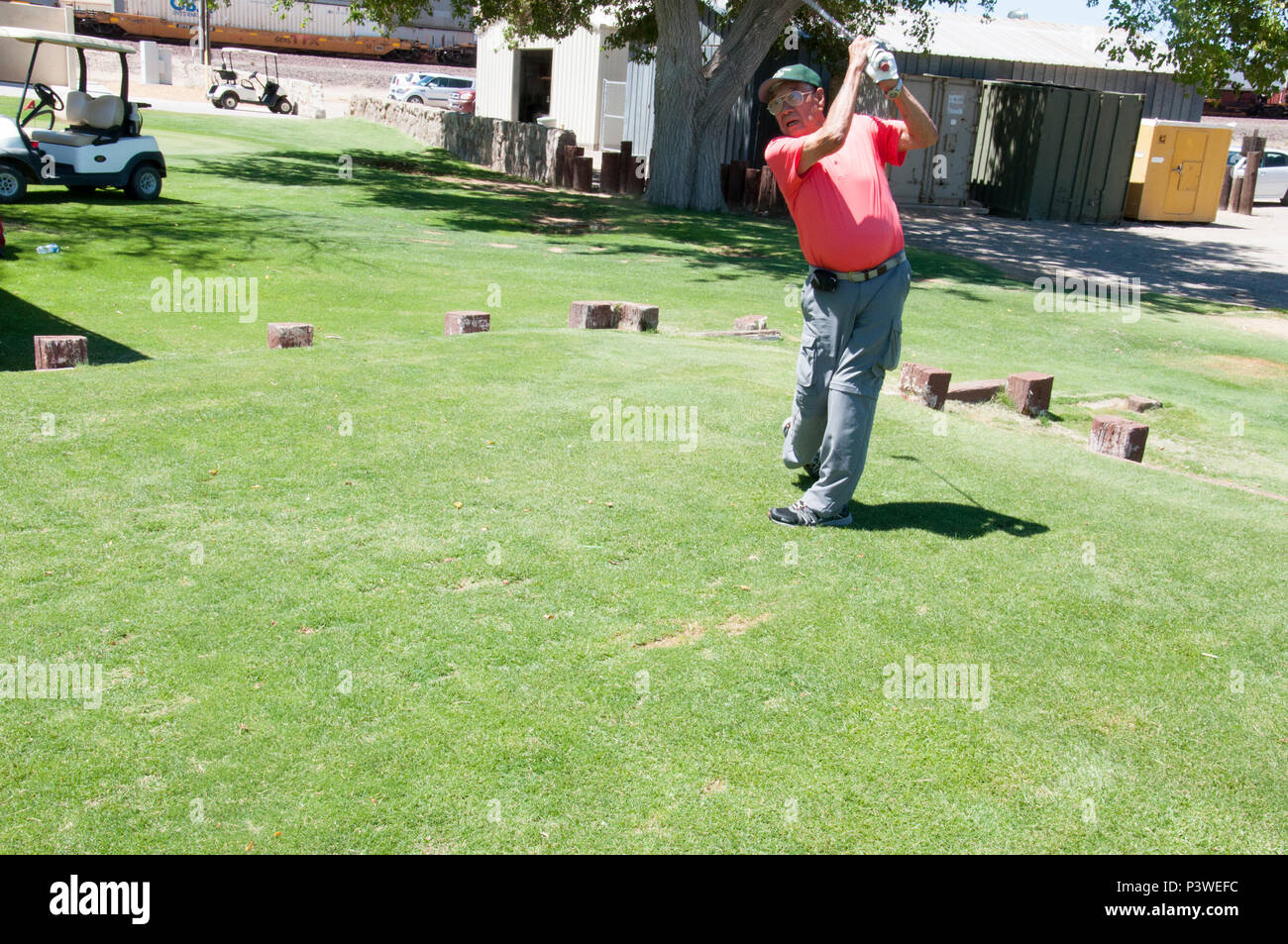 Golf instructor Oscar Valenzuela follows through on a swing at the Tees and Trees Golf course