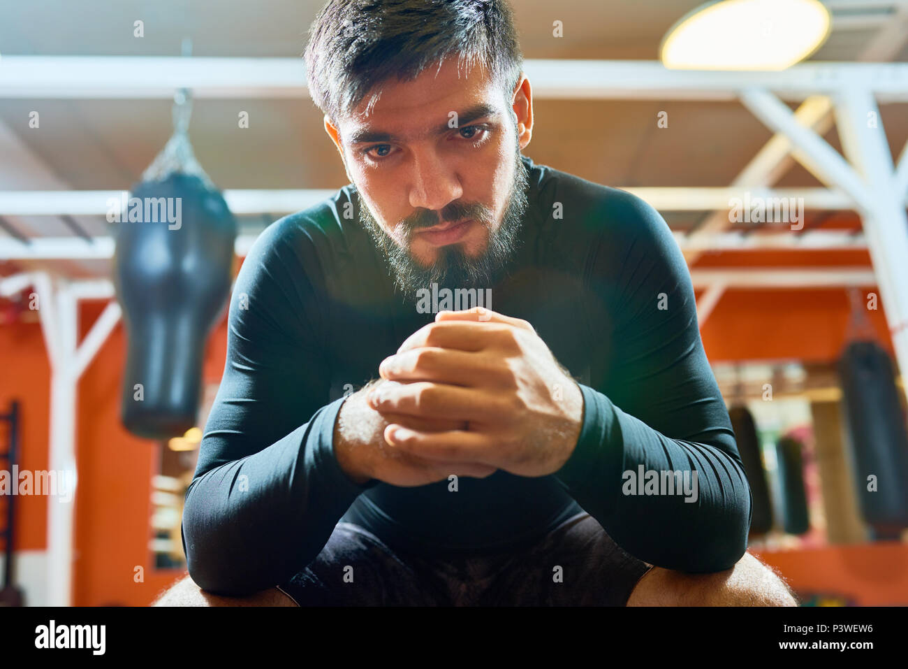 Brutal bearded sportsman in boxing gym Stock Photo