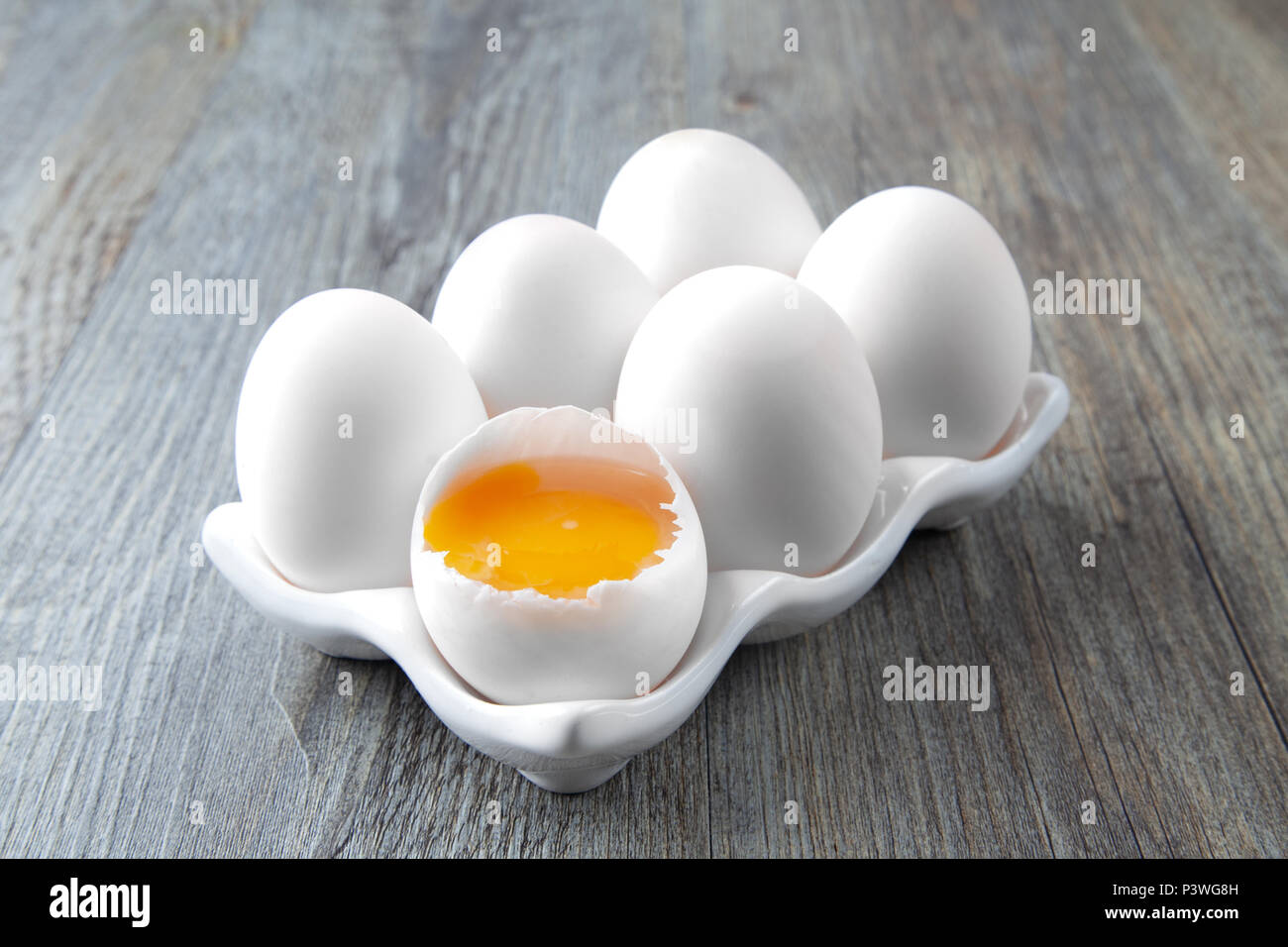 Six Large White Eggs on a White Ceramic Dish Stock Photo
