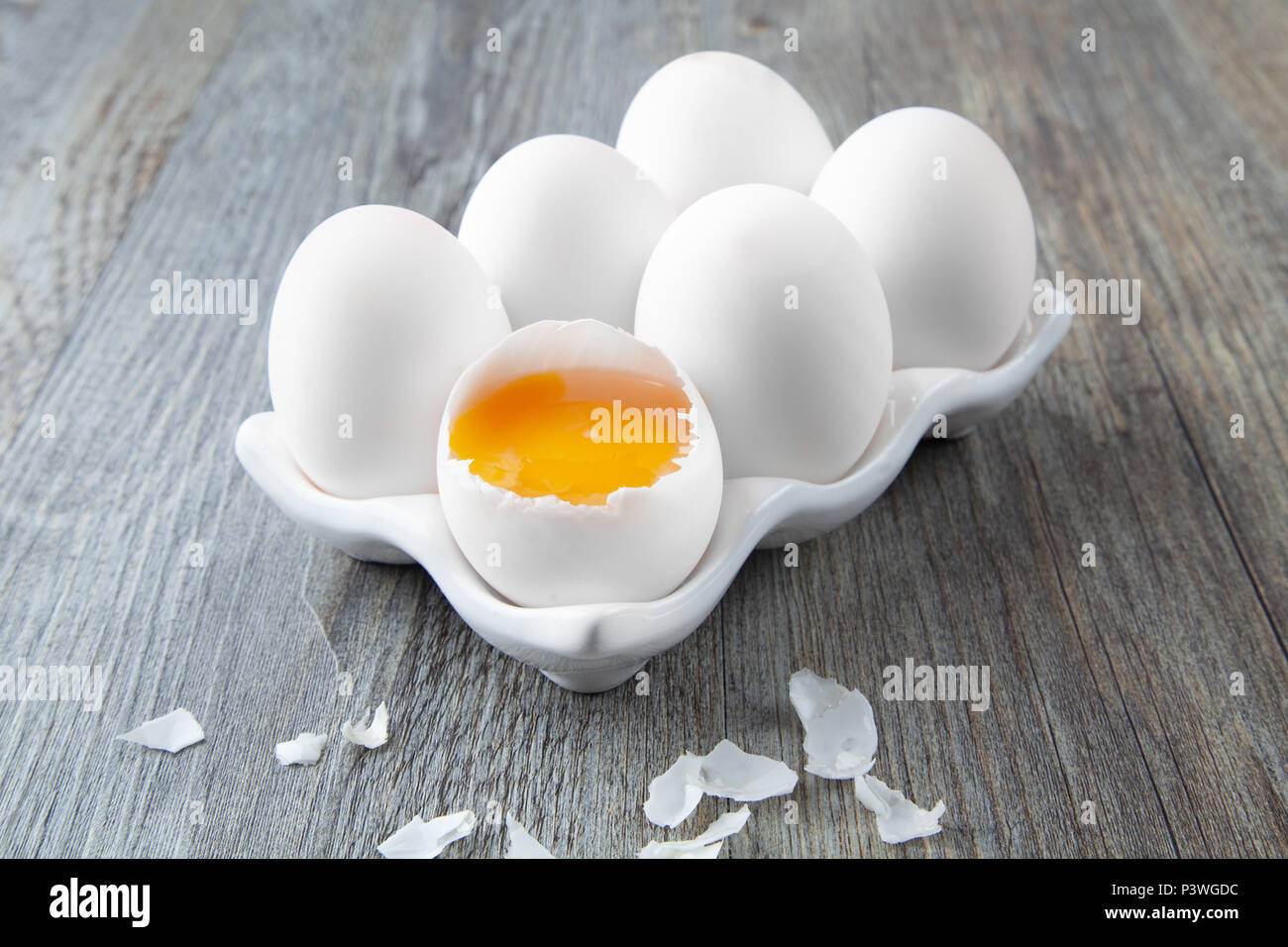 Six Large White Eggs on a White Ceramic Dish Stock Photo
