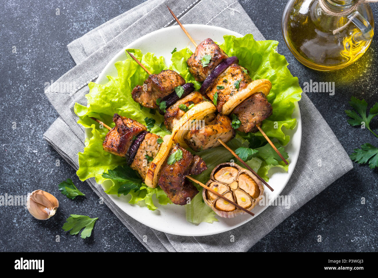 Grilled Shish Kebab Or Shashlik On Skewers With Salad Leaves On Black