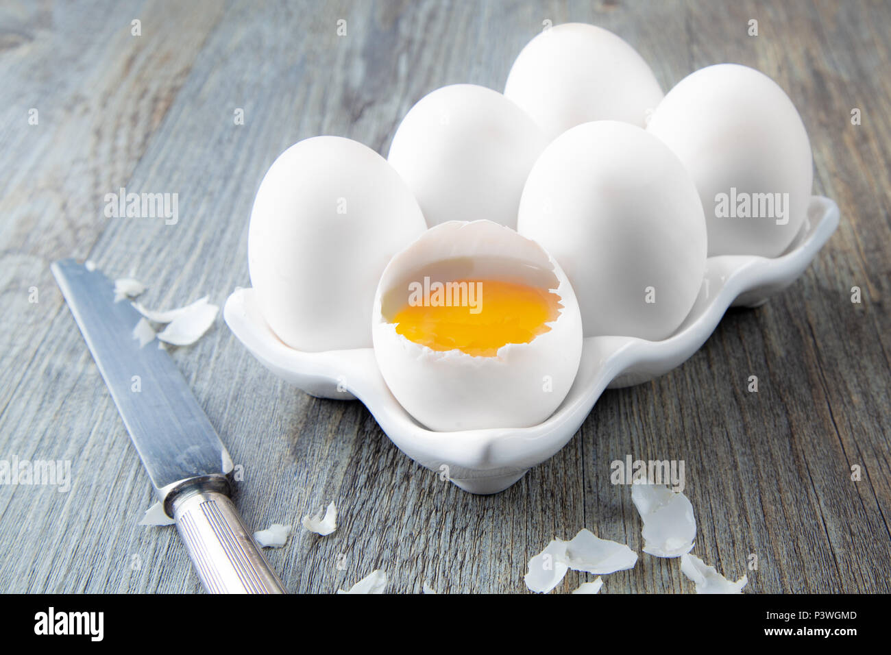 Six Large White Eggs on a White Ceramic Dish Stock Photo