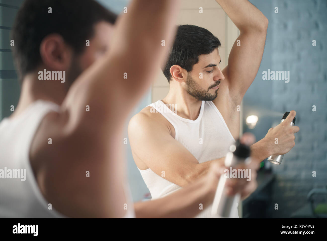 Man Using Spray Deodorant On Underarm For Bad Smell Stock Photo Alamy