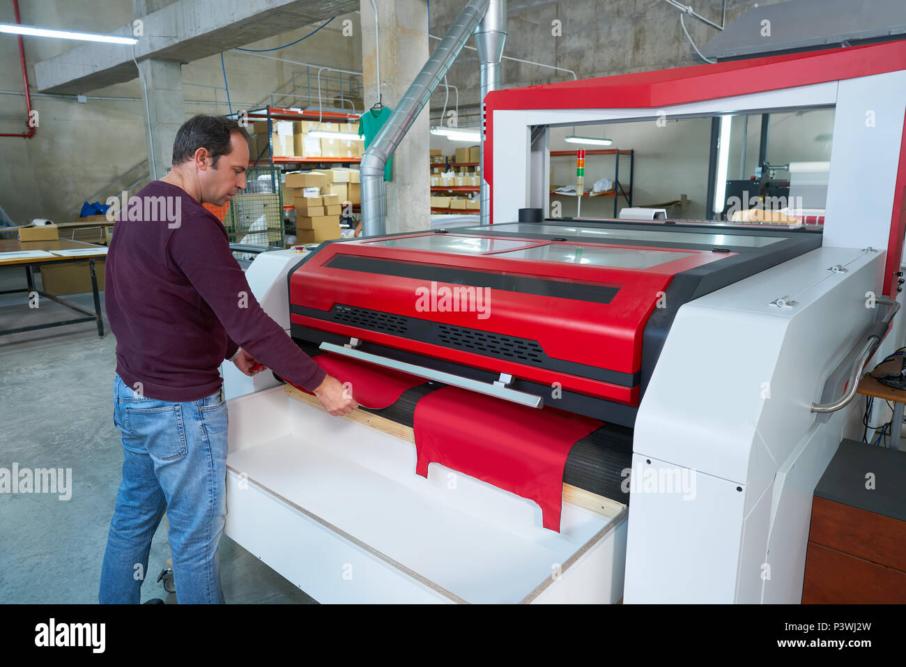 Laser cutting machine production operator for textile transfer fashion  industry factory Stock Photo - Alamy