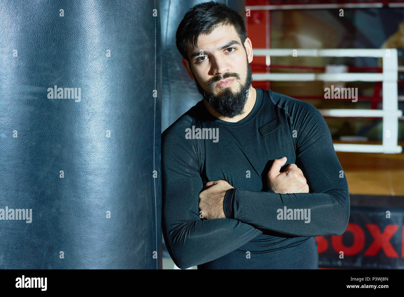 Confident bearded boxer in gym Stock Photo