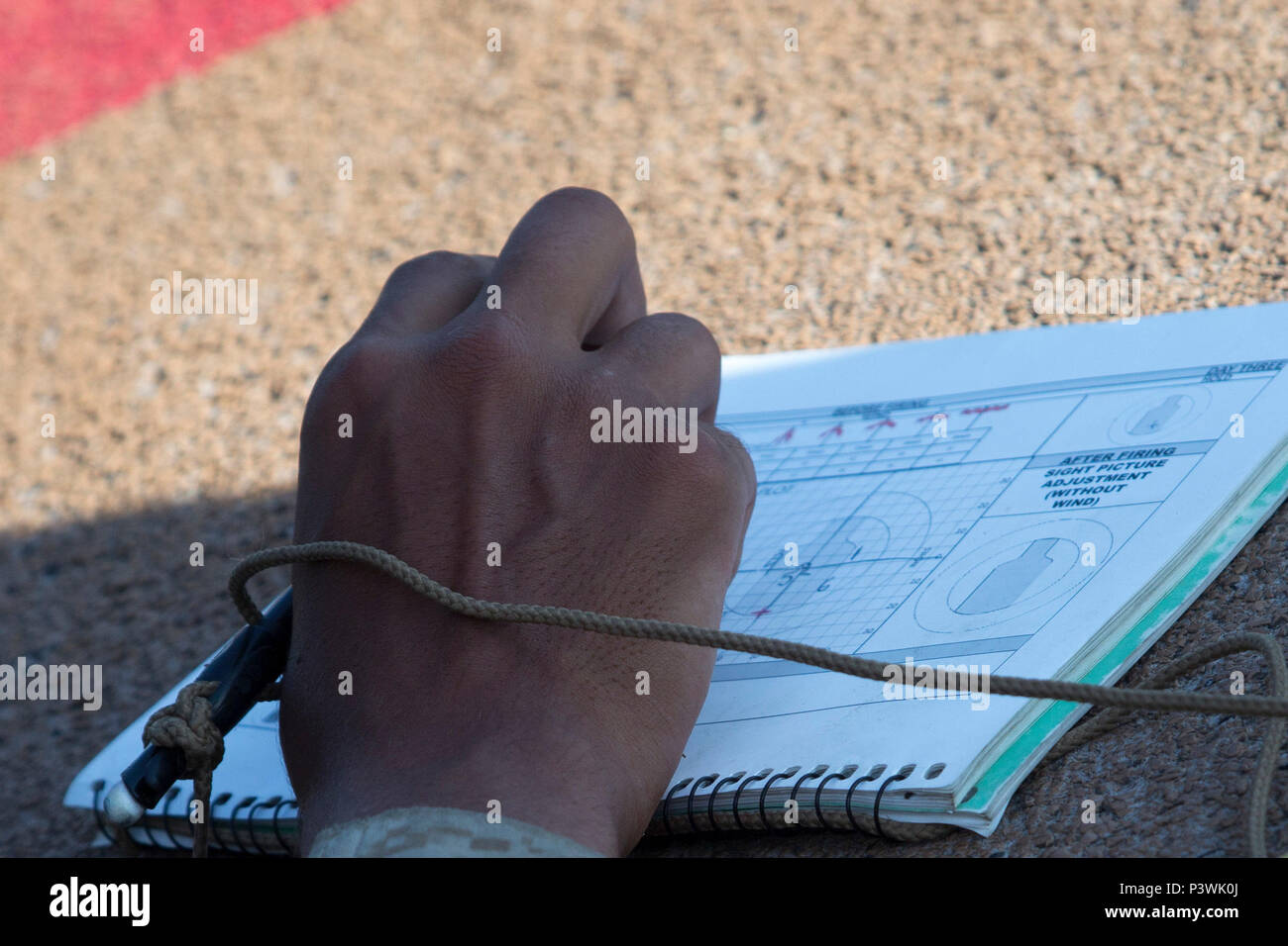 A recruit of Echo Company, 2nd Recruit Training Battalion, marks his shot during marksmanship training July 13, 2016, on Parris Island, S.C. Recruits keep a careful log of their shots in order to track and improve their shooting abilities. Echo Company is scheduled to graduate Aug. 19, 2016. Parris Island has been the site of Marine Corps recruit training since Nov. 1, 1915. Today, approximately 19,000 recruits come to Parris Island annually for the chance to become United States Marines by enduring 12 weeks of rigorous, transformative training. Parris Island is home to entry-level enlisted tr Stock Photo