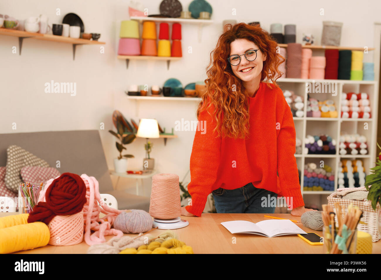 Creative girl in oversize sweater spending time in art studio Stock Photo