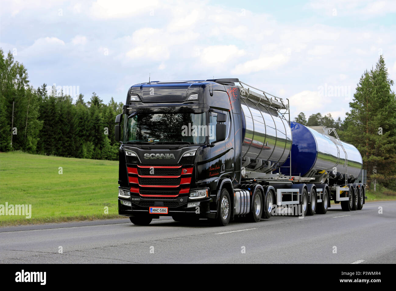 Black and red Next Generation Scania R650 tank truck of R Laakso hauls goods along highway in the summer. Uurainen, Finland - June 15, 2018. Stock Photo