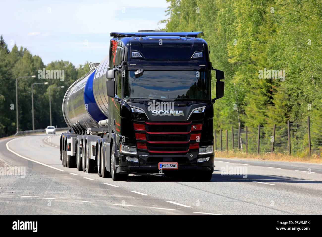 Black and red Next Generation Scania R650 tank truck of R Laakso hauls goods along highway in the summer. Kangasala, Finland - June 14, 2018. Stock Photo