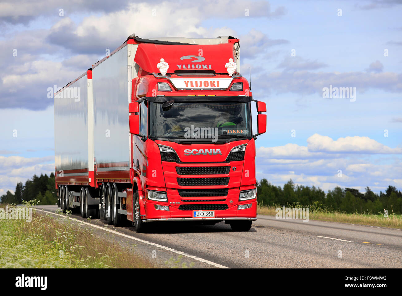 Red Next Generation Scania R650 truck and woodchip transport trailer of Ylijoki Kuljetus in summer road landscape in Jamsa, Finland - June 14, 2018. Stock Photo