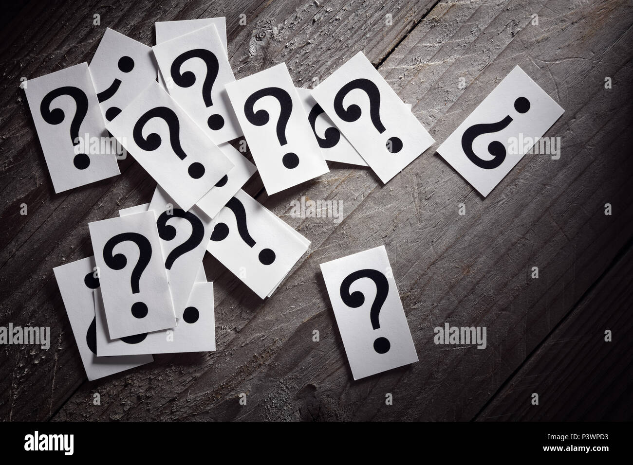 Question mark heap on table concept for confusion, question or solution Stock Photo