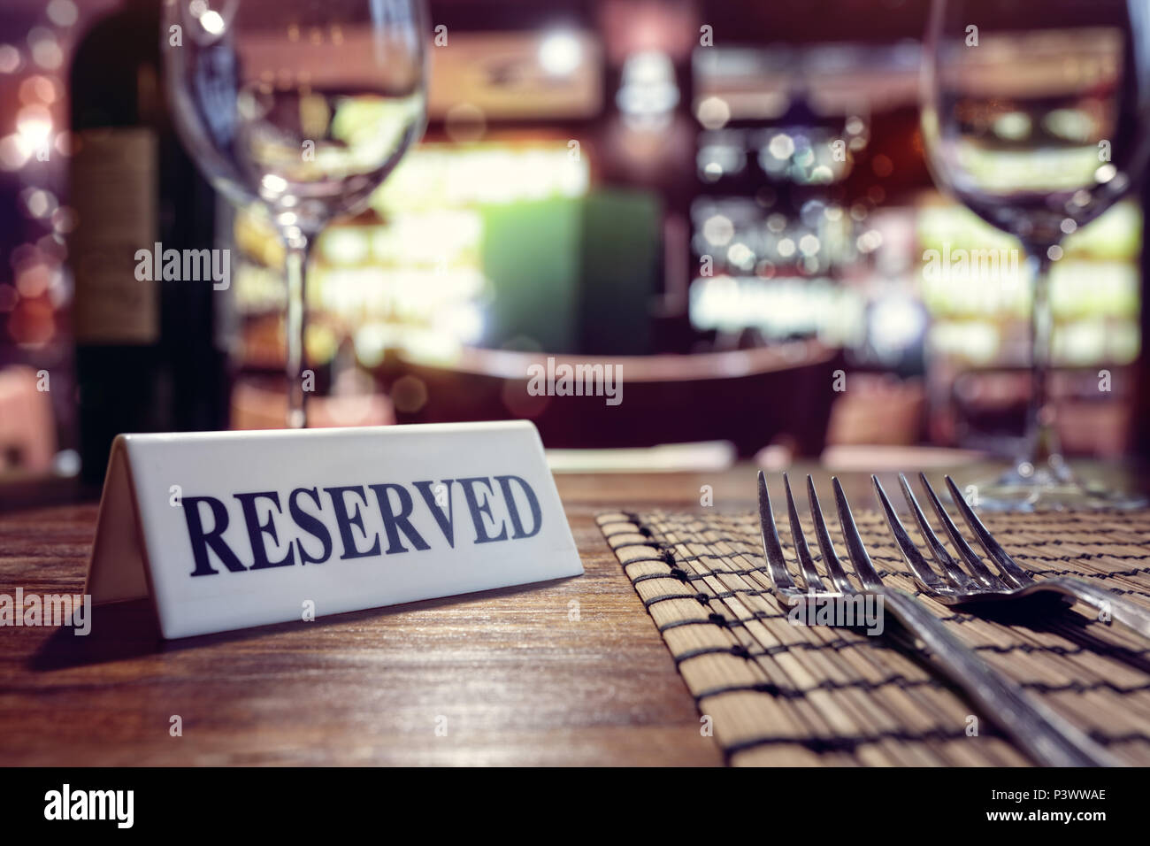 Restaurant reserved table sign with places setting and wine glasses ready for a party Stock Photo