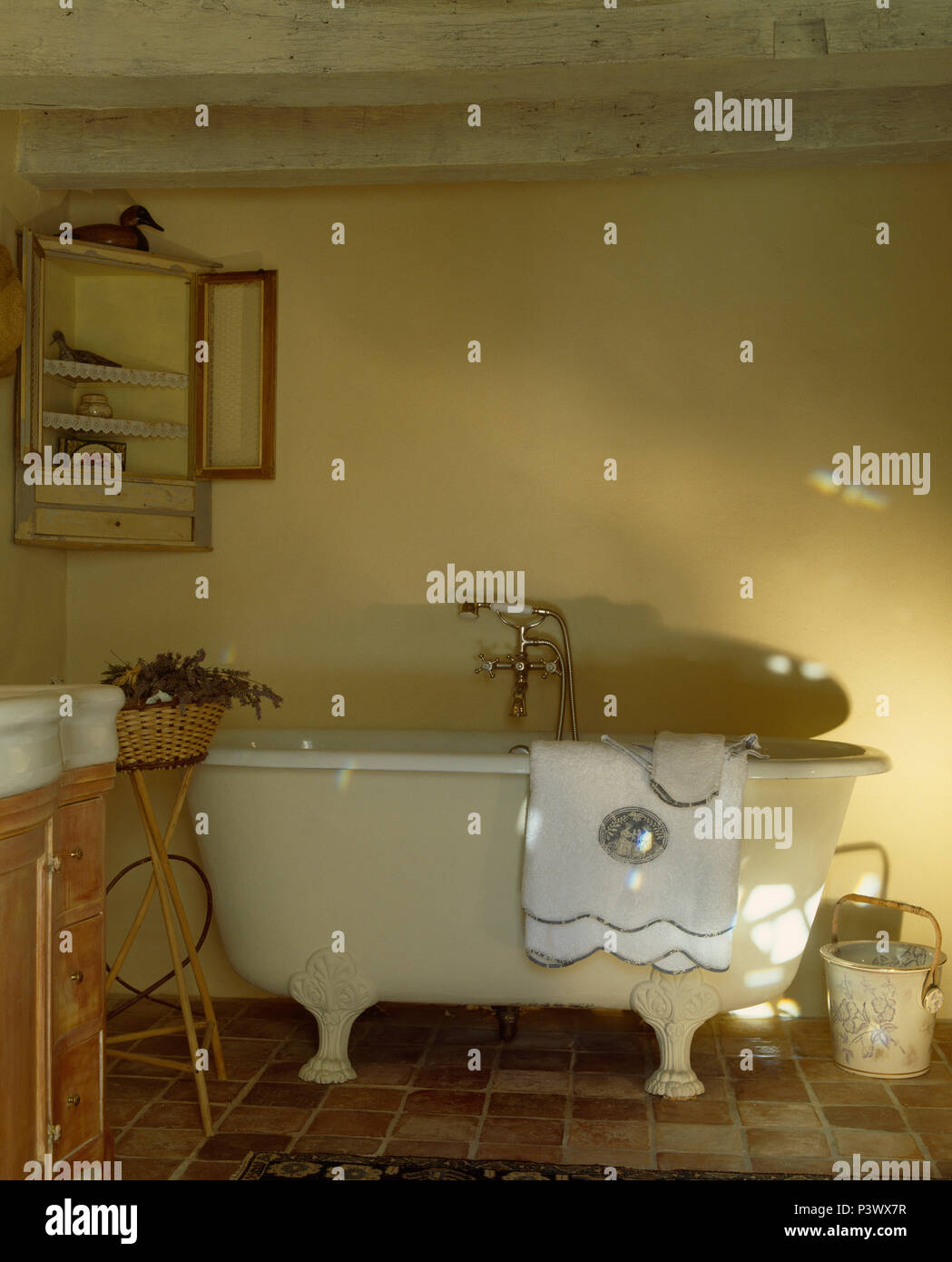 White Towel On Old Claw Foot Bath In Pale Yellow French Country