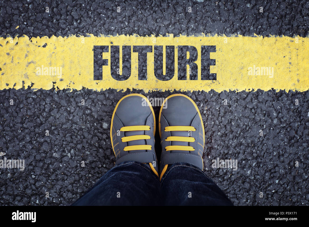 Future line child in sneakers standing next to a yellow line Stock Photo