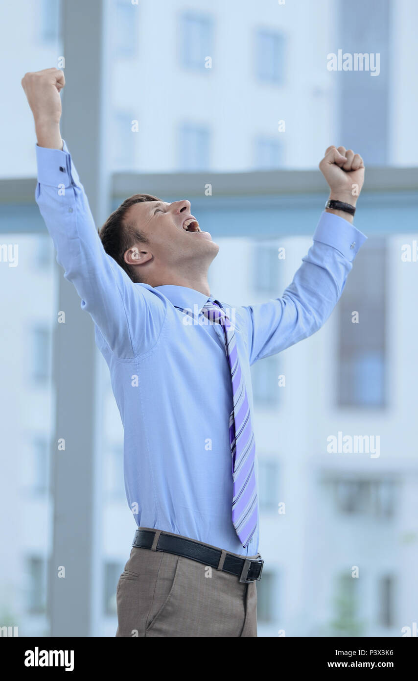 Businessman celebrating with his fists raised in the air Stock Photo ...