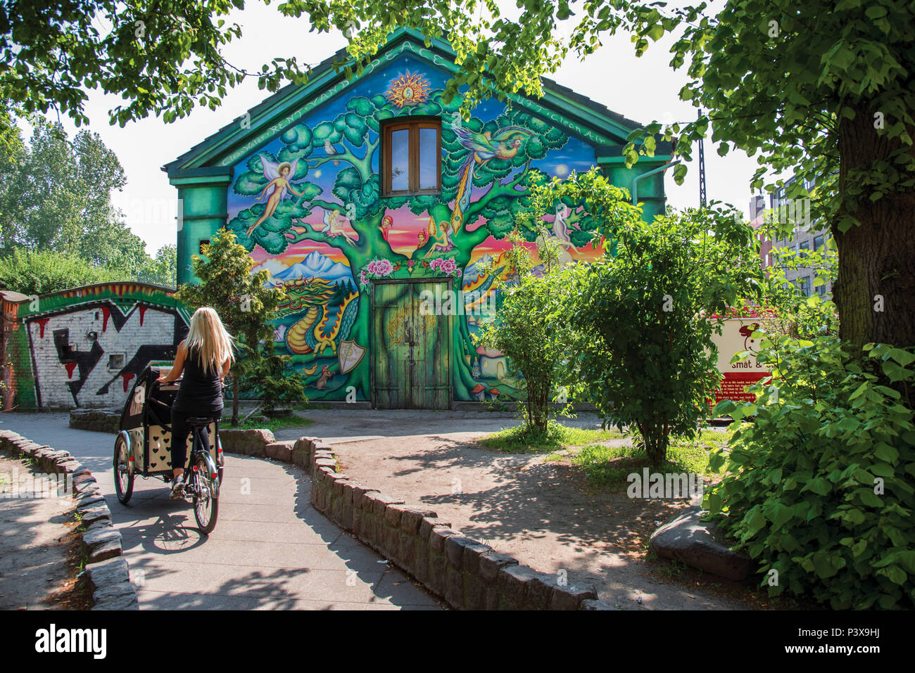 Cyclist in Freetown Christiania, Copenhagen Denmark Stock Photo