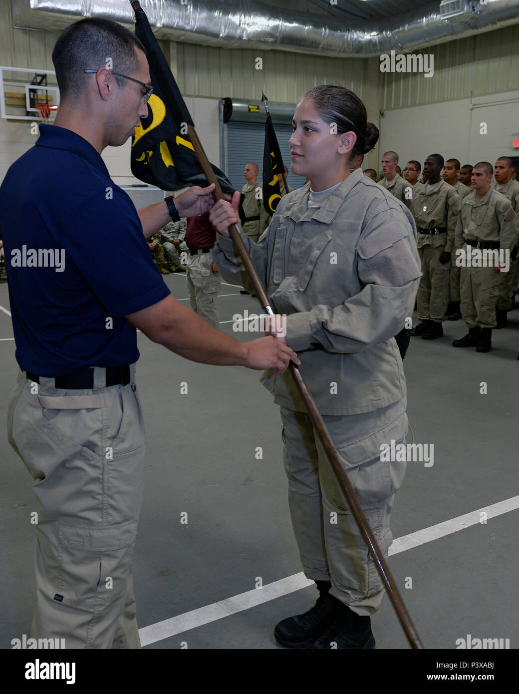 Trey Rocha, Texas ChalleNGe Academy-East commandant, hands off a guidan ...