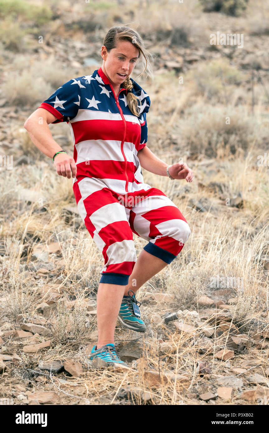 Female athlete dressed in American Flag costume competes in a foot race and climb up 'S' Mountain (Tenderfoot Mountain) during the annual Fibark Festi Stock Photo