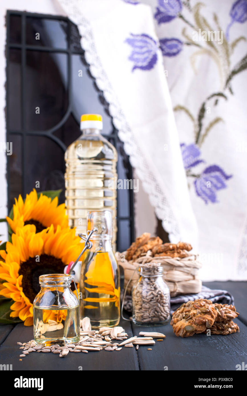 Sunflower oil and large yellow flowers near the window. Oil in the