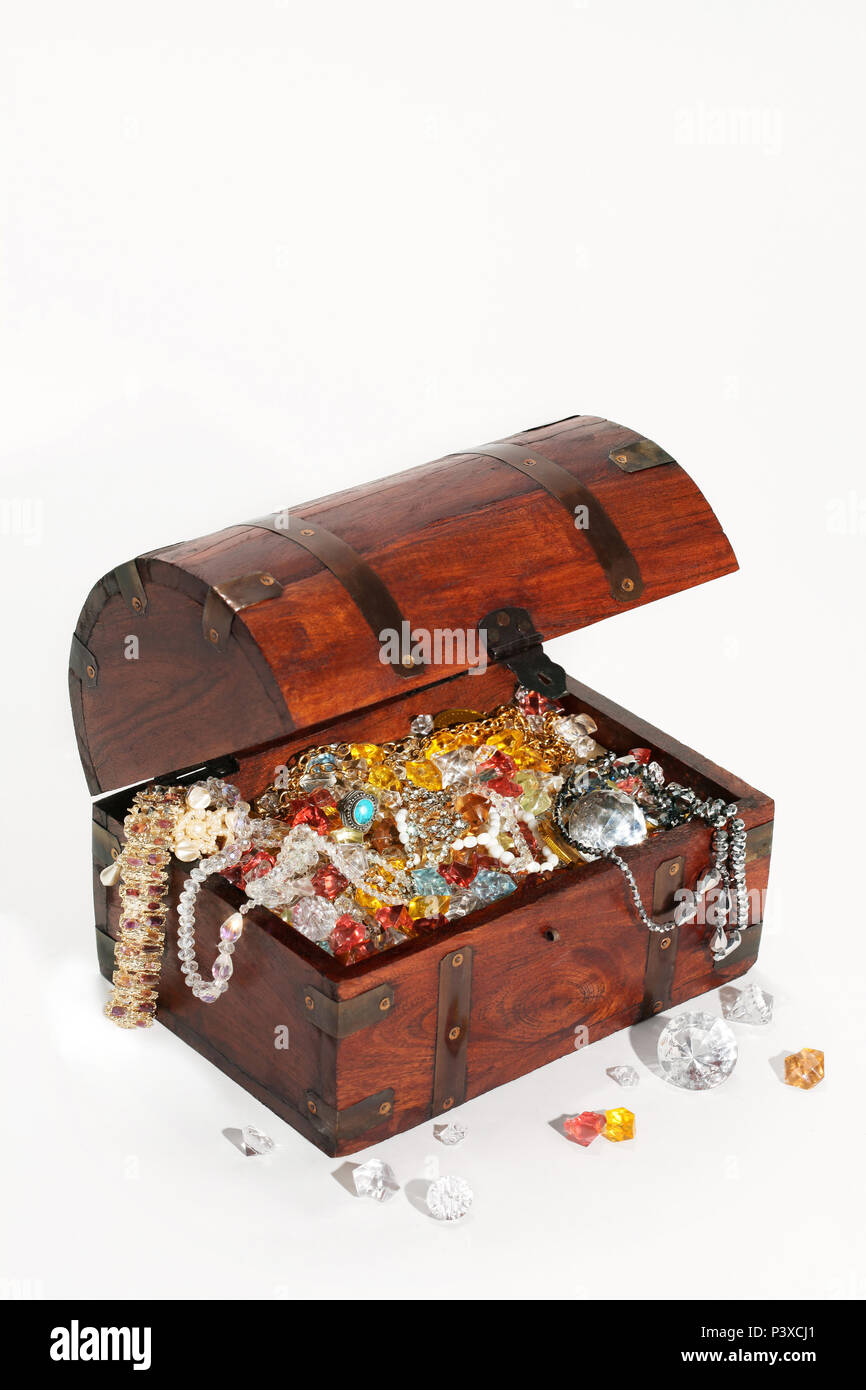 Retro treasure chest filled with precious stones and jewelry. Isolated