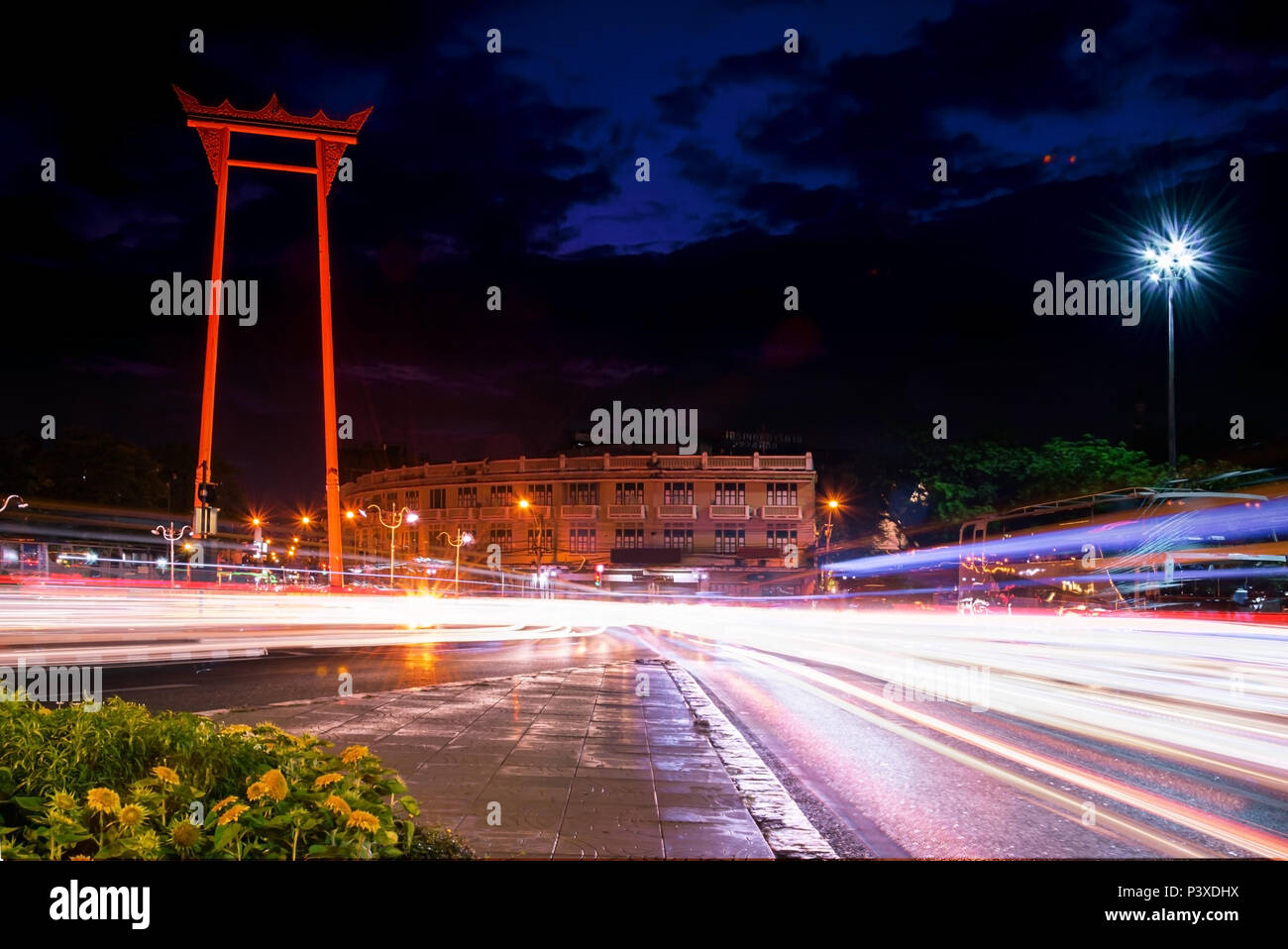 Giant Swing, a cultural landmark of Bangkok Thailand, an evening atmosphere. The sun is falling, the dense traffic, the light is a beam line. Stock Photo