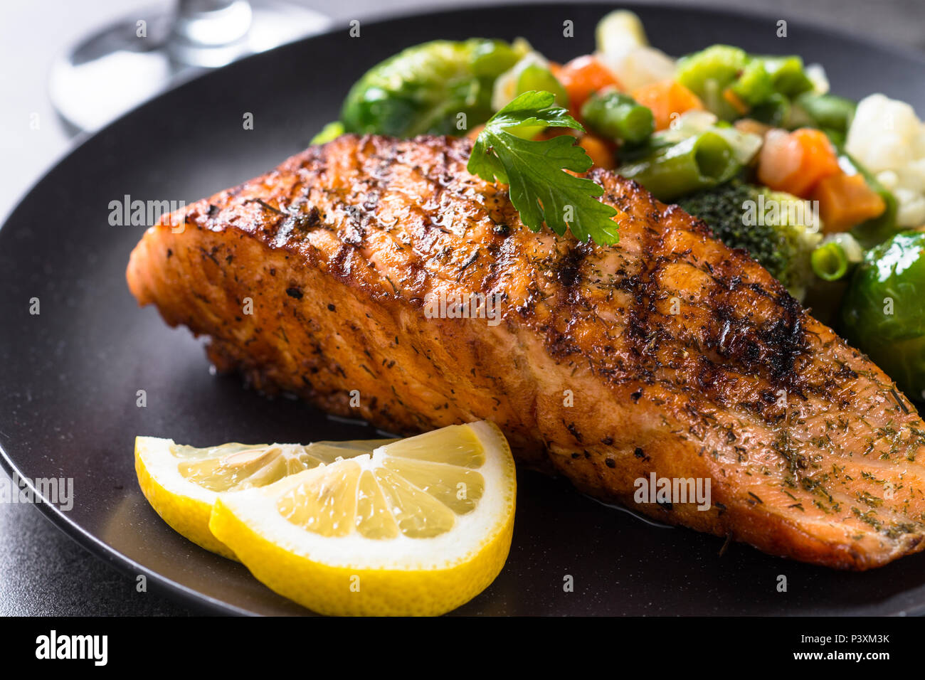 Grilled salmon fillet with vegetables mix. Close up Stock Photo - Alamy