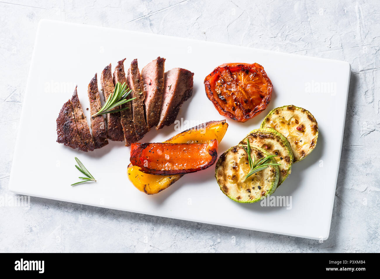 Barbecue dish. Beef steak and grilled vegetables. Top view with Stock