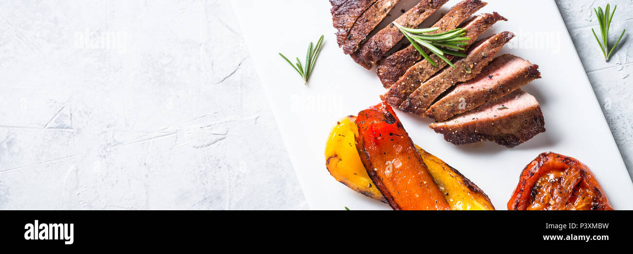 Barbecue dish. Beef steak and grilled vegetables. Long banner format