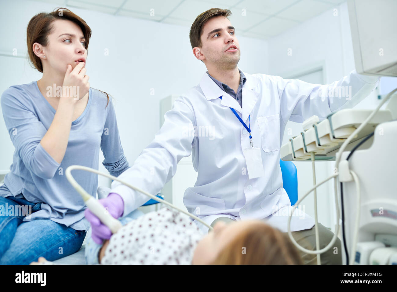 Doctors seriously looking at medical device Stock Photo