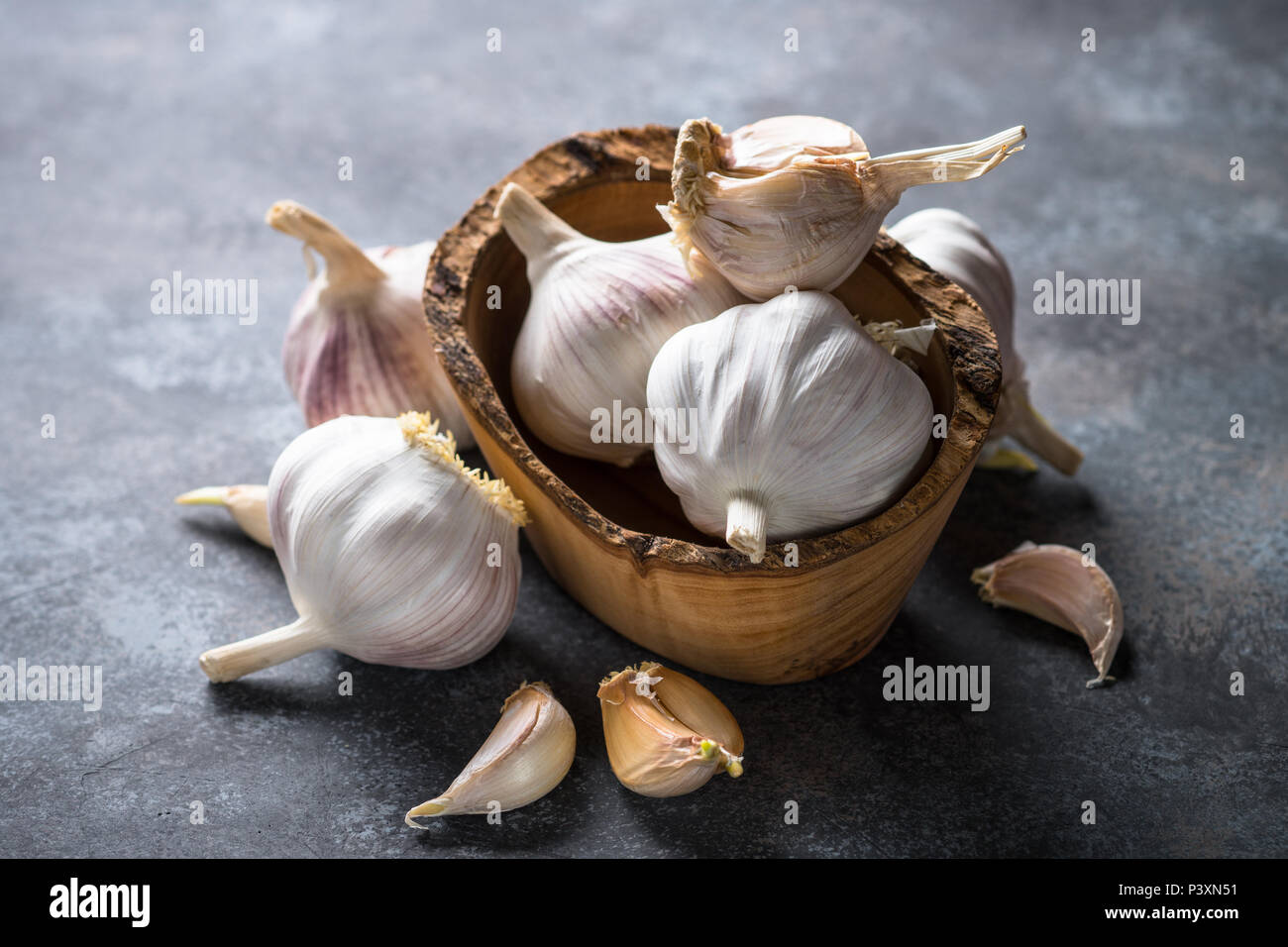 Garlic cloves on a dark stone background. Top view, Copy space Stock ...