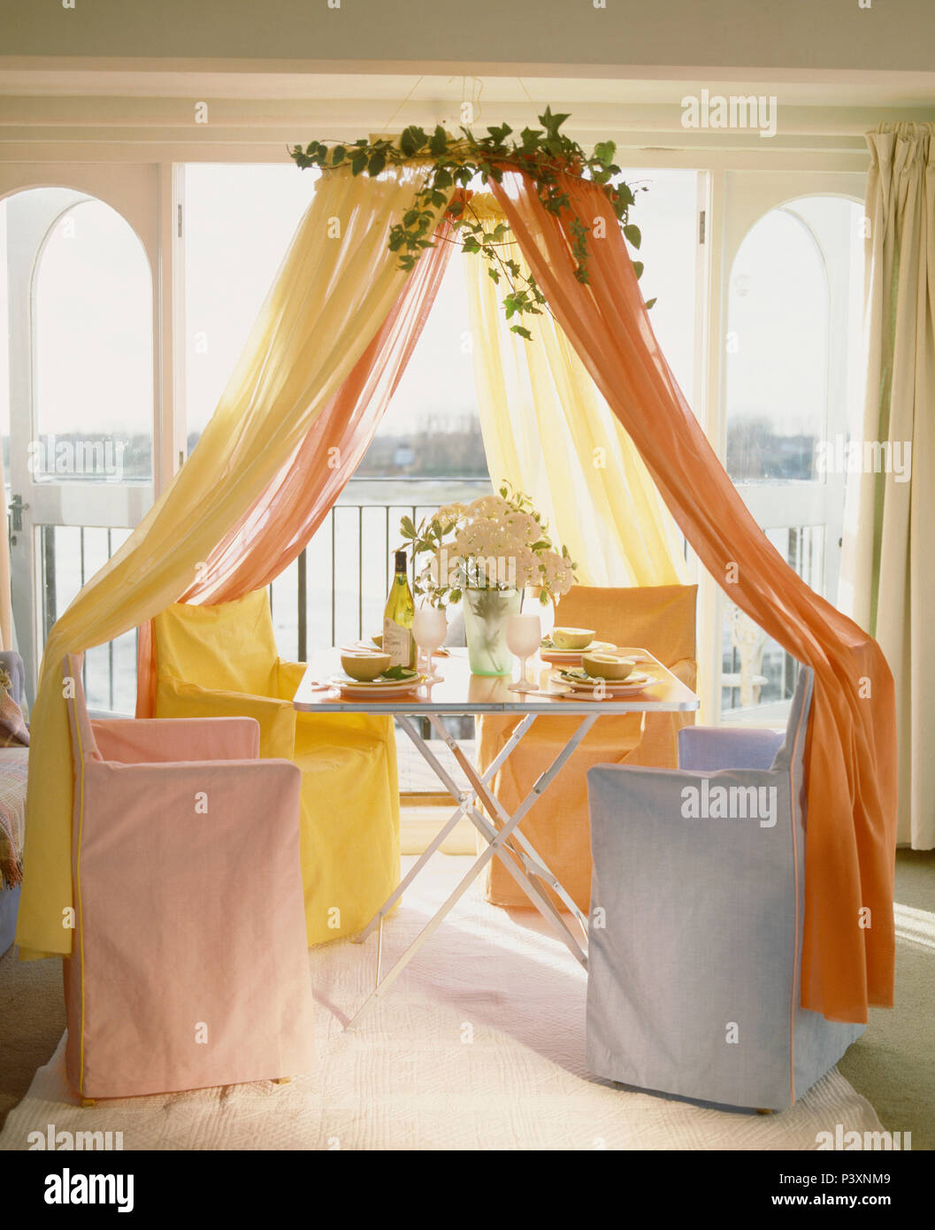 Coronet With Orange And Yellow Voile Drapes Above Table And