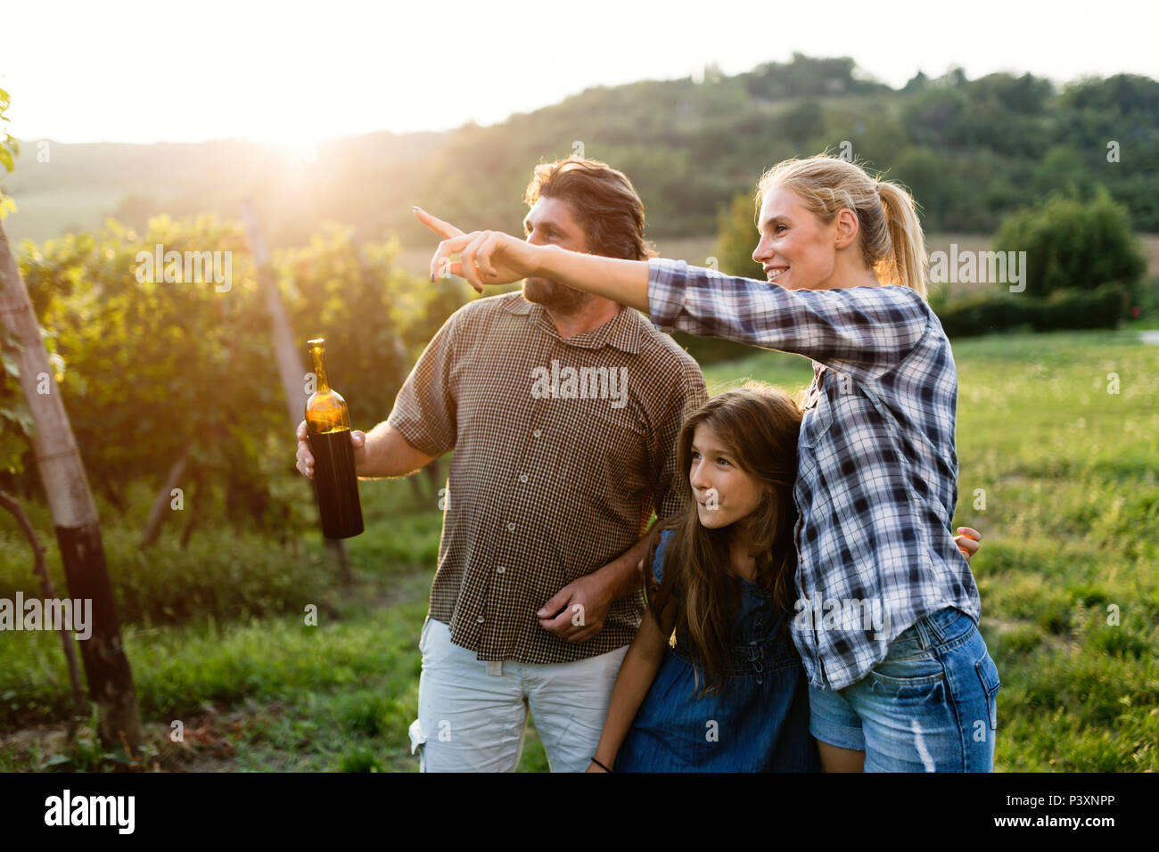 Wine grower family together in vineyard Stock Photo