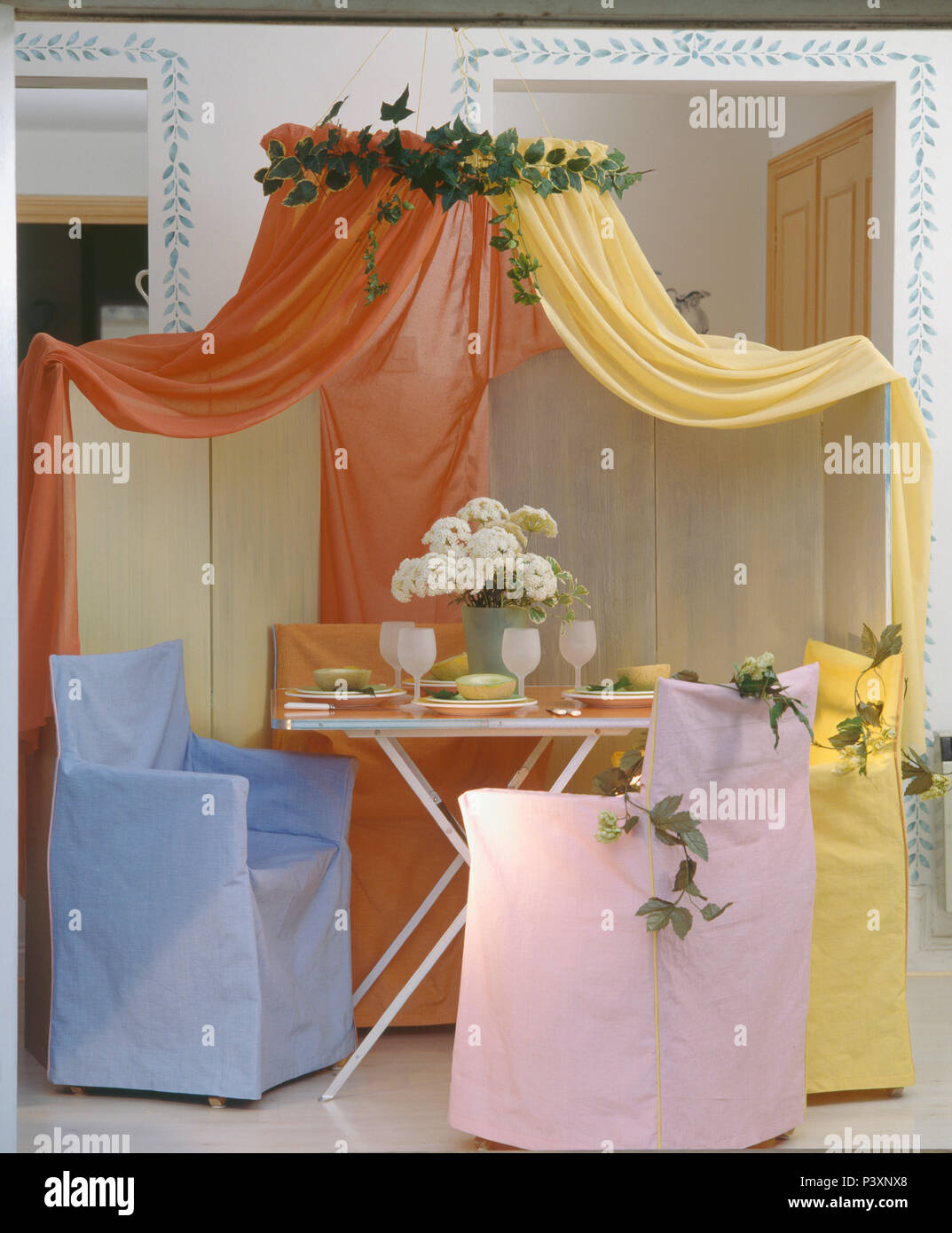 Orange And Yellow Voile Drapes Above Table And Director S