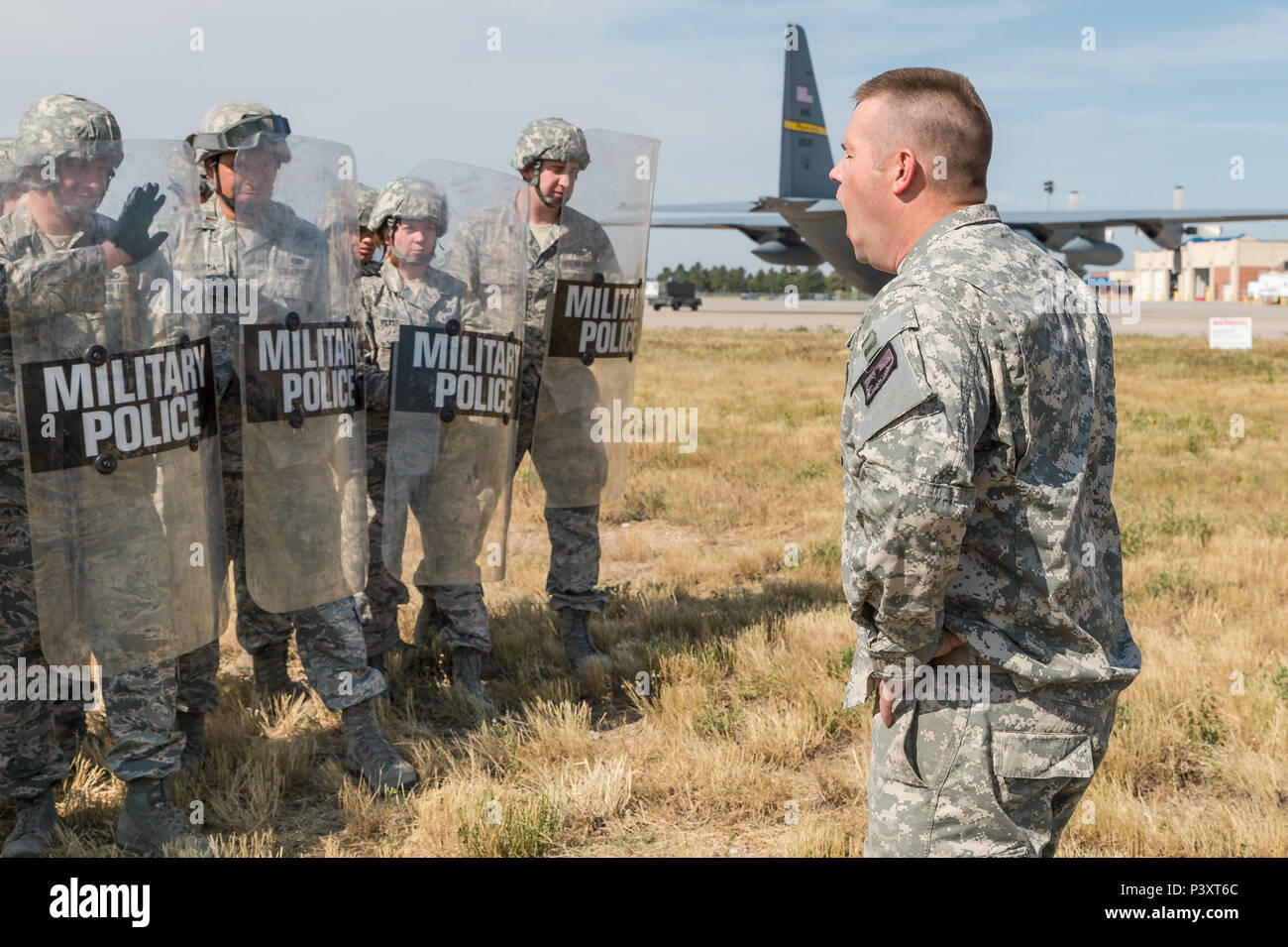 U.S. Army Staff Sgt. Jared Lee with the Camp Guernsey Joint Training Center  shouts riot control commands to airmen with the 153rd Security Forces  Squadron, July 26, 2016 at the Air National