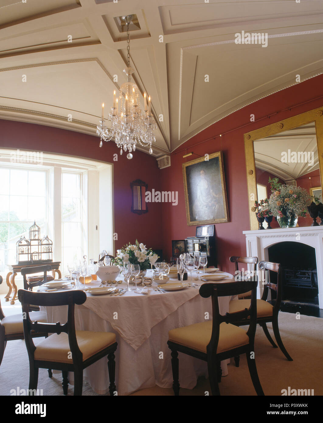 Antique Chairs At Table Set For Lunch With White Linen Cloth In Red Country Dining Room Vaulted Ceiling Antique Chairs At Table Set For Lunch With White Linen Cloth In Red Country Dining Room Vaulted Ceiling
