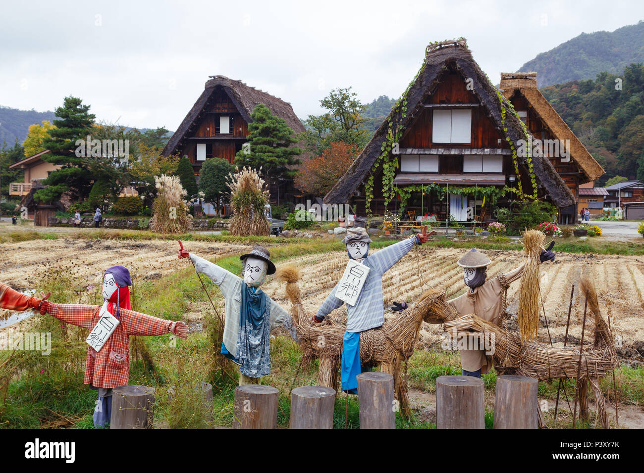 Scarecrows in front of traditional wooden houses in Shirakawa-go village, Japan Stock Photo