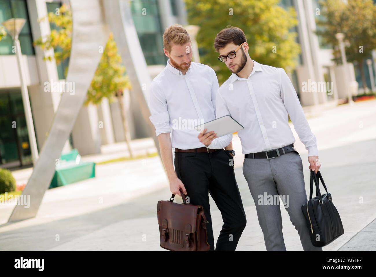 Business people talking outdoors Stock Photo - Alamy
