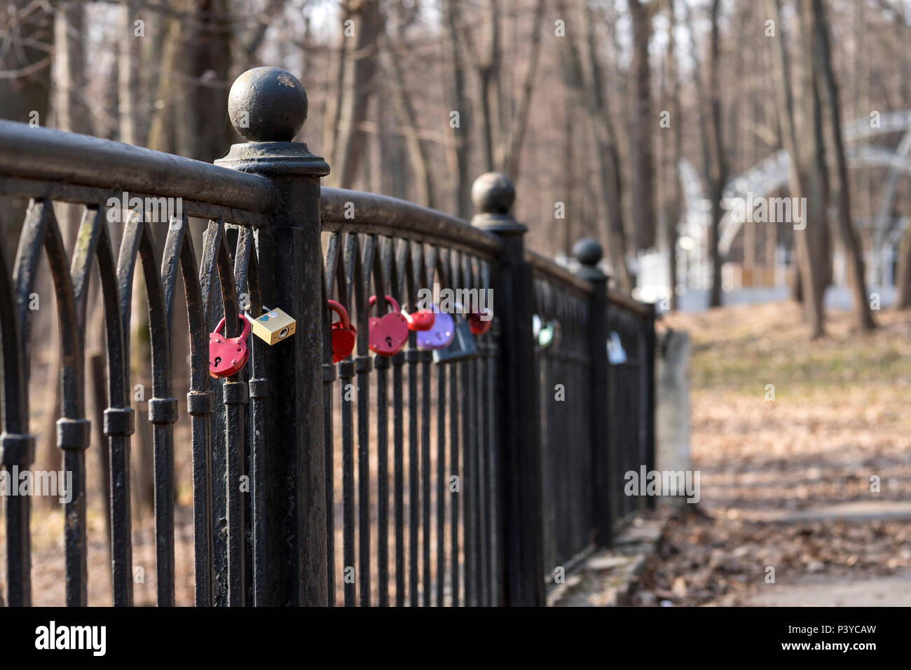 lock on the fence on the bridge as a symbol of love. The key is thrown into the lake. Stock Photo
